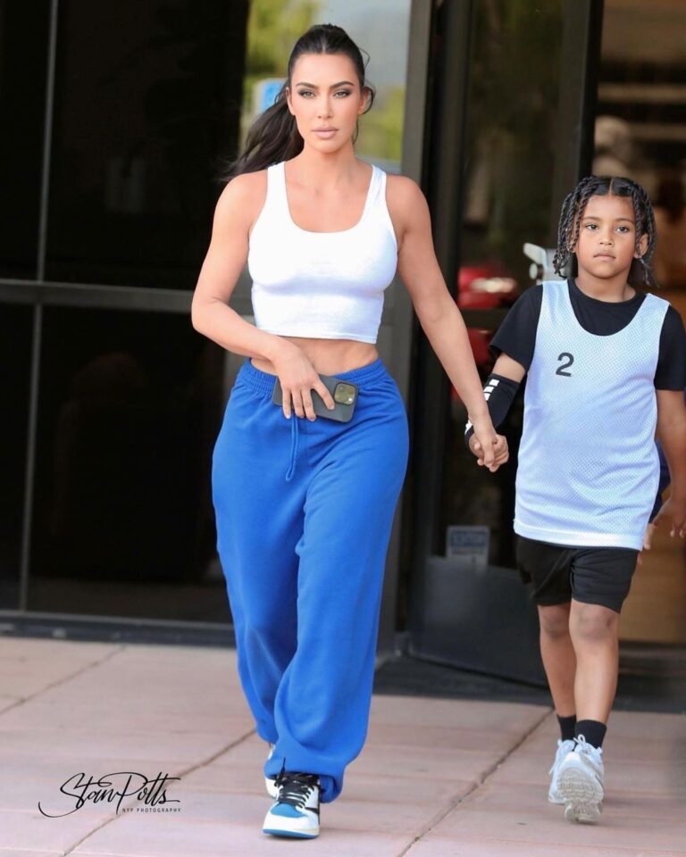 Kim Kardashian Wore a White Crop Top and Blue Sweatpants with Travis Scott Air Jordan 1’s to Saint West Basketball game in L.A.